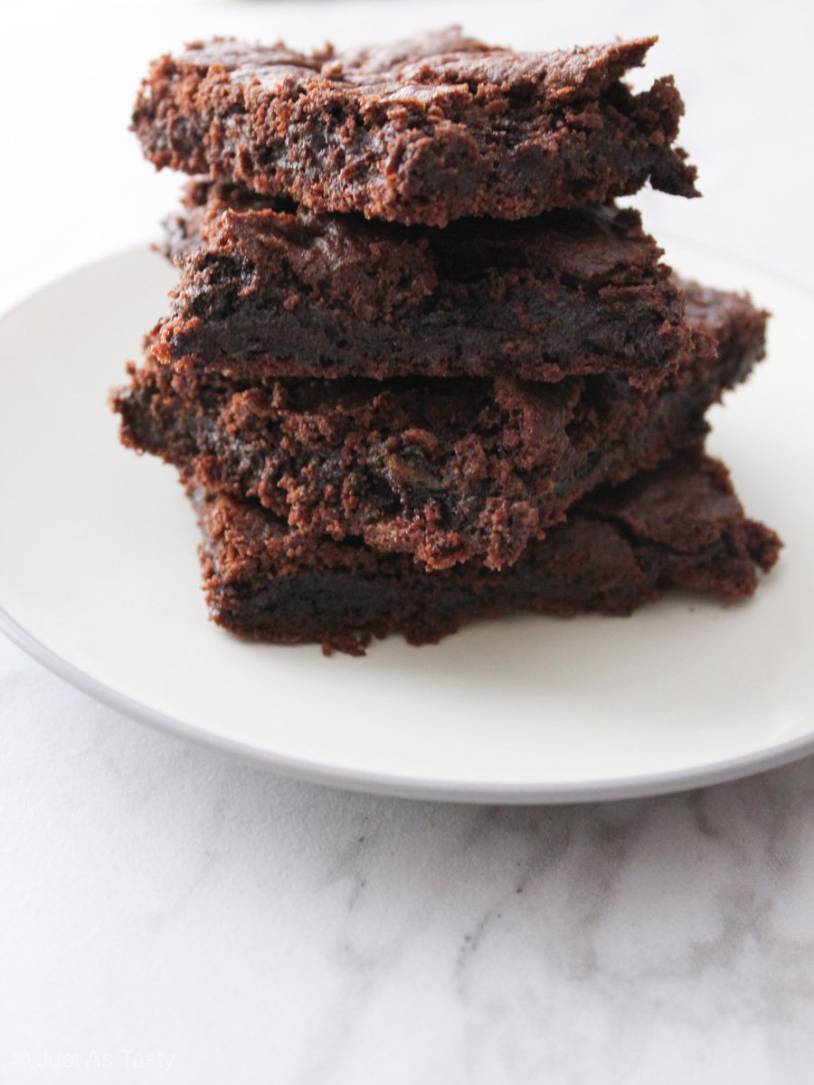 Brownies stacked on a white plate