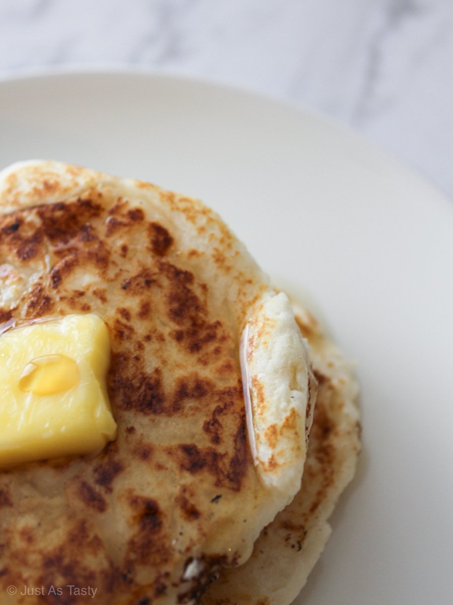 Stack of pancakes topped with butter.