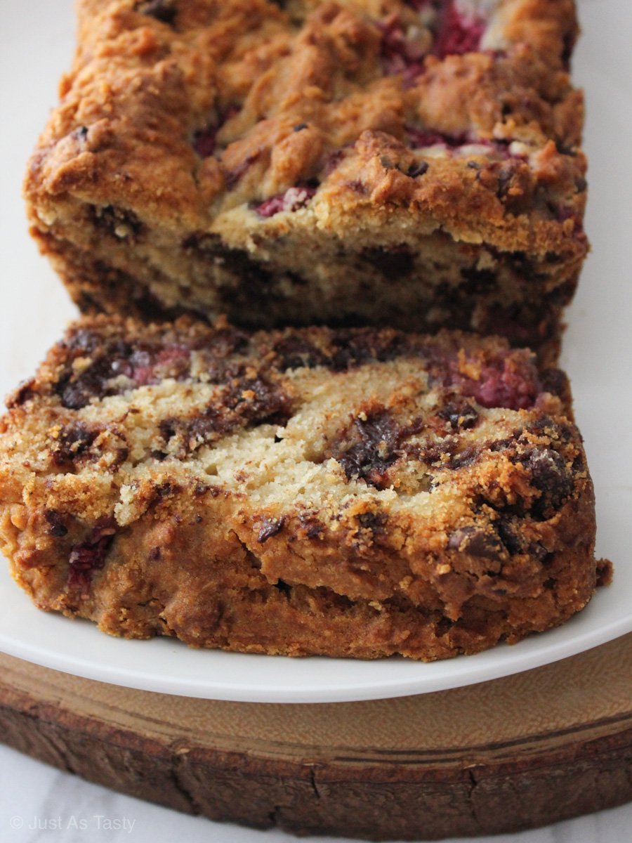 Sliced dark chocolate raspberry bread on a white plate.