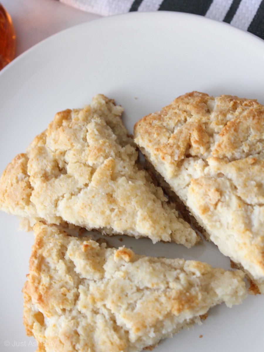 Three eggless scones on a white plate.