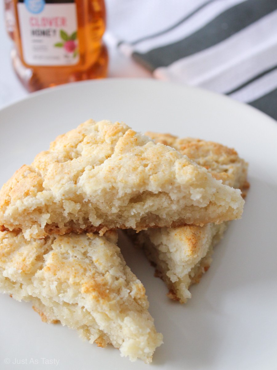 Eggless scones stacked on a white plate.