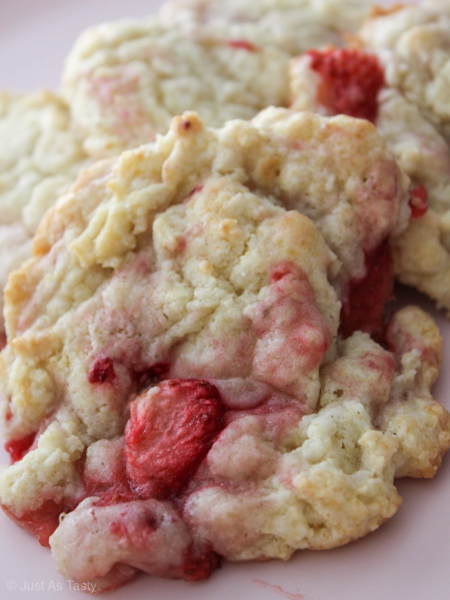 Close-up of strawberry cream cheese cookies on pink plate.