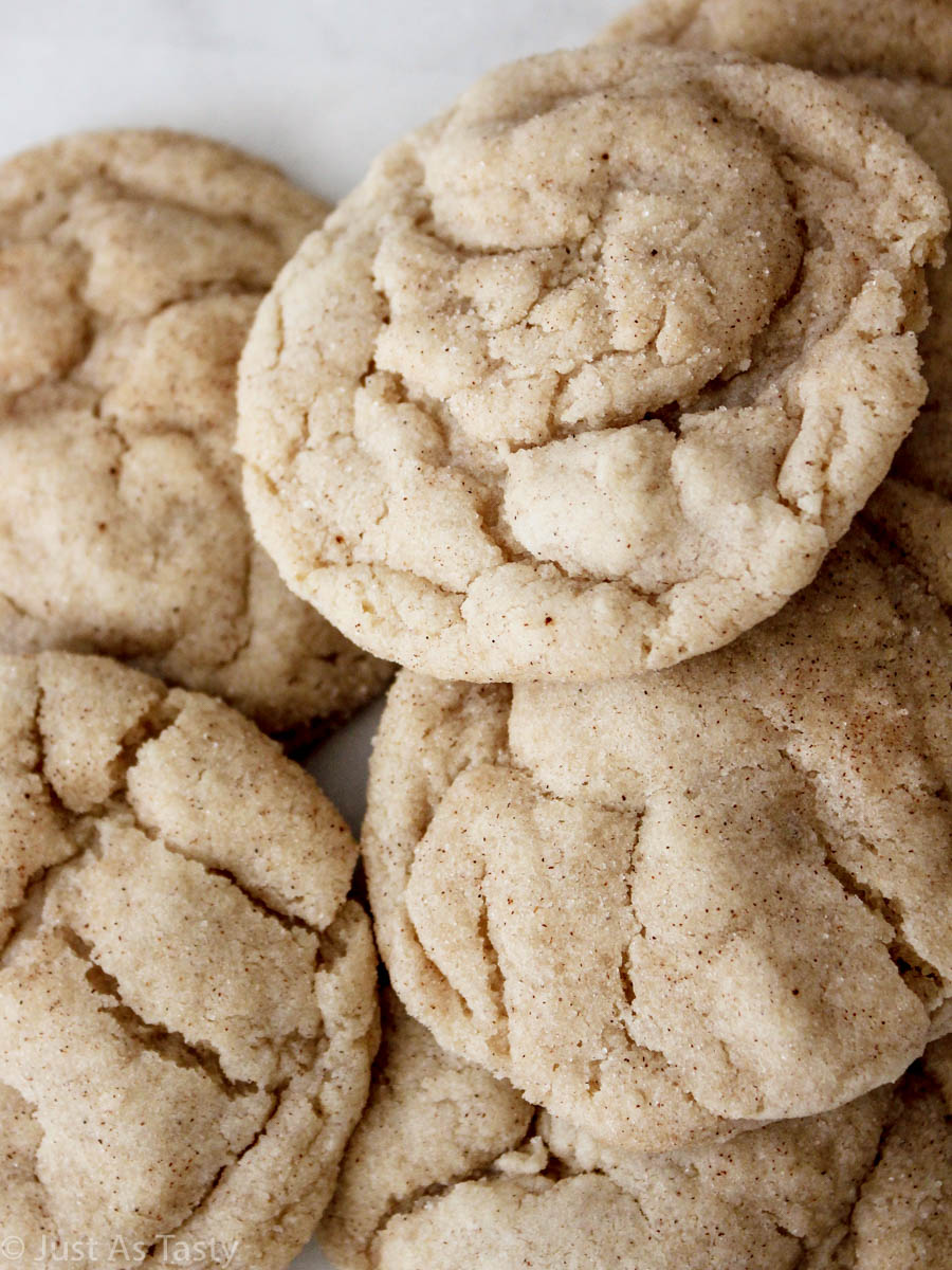 Close-up of gluten free snickerdoodles piled on a white plate. 
