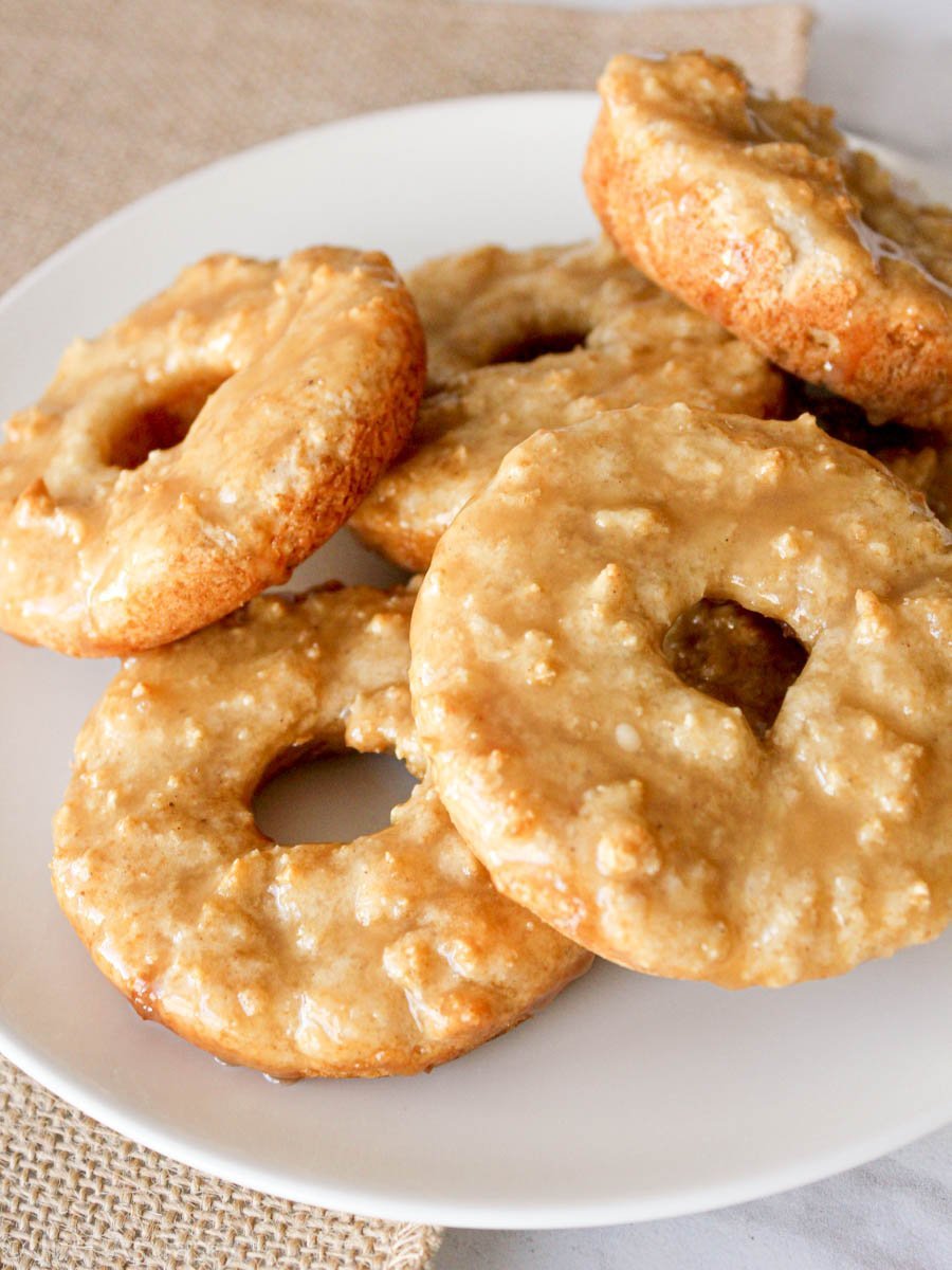 Maple glazed donuts on a white plate.