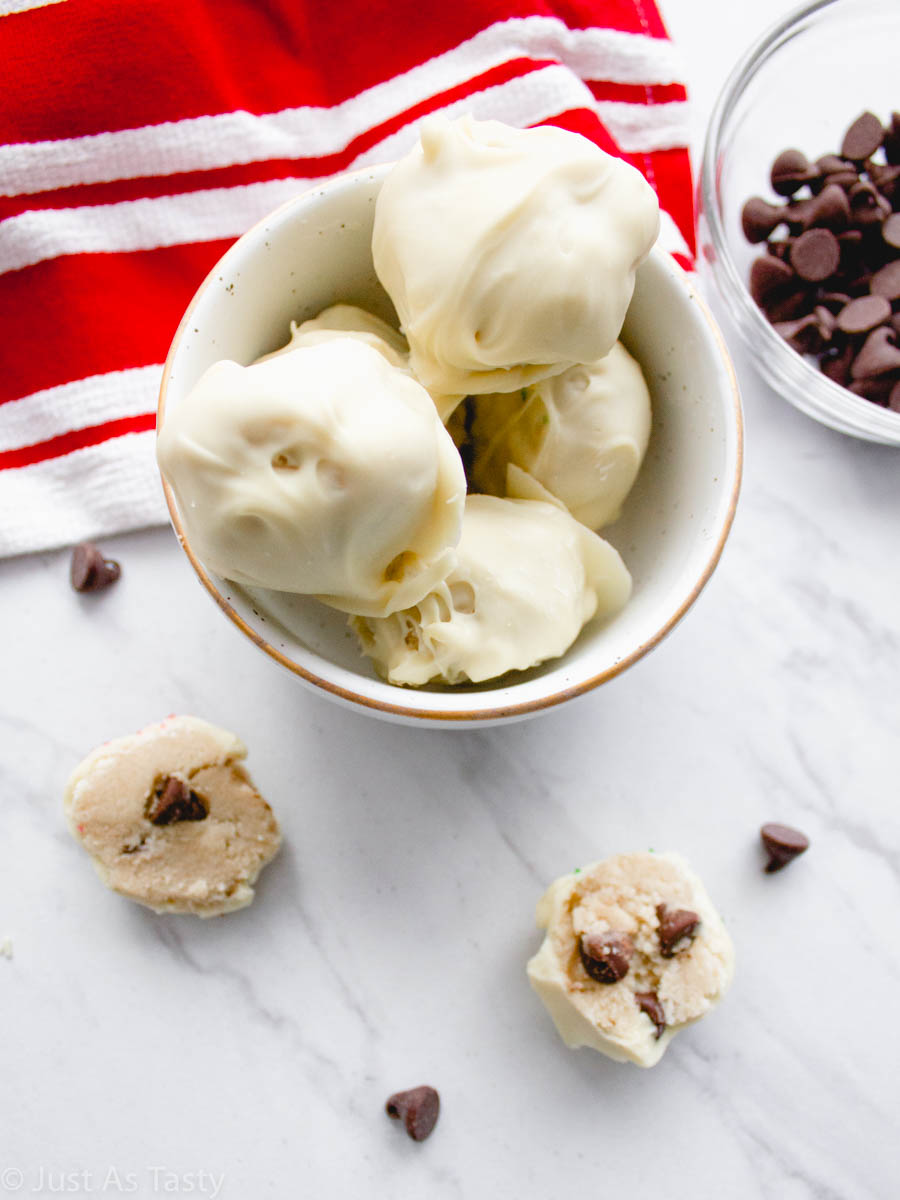White chocolate cookie dough truffles in a white bowl.