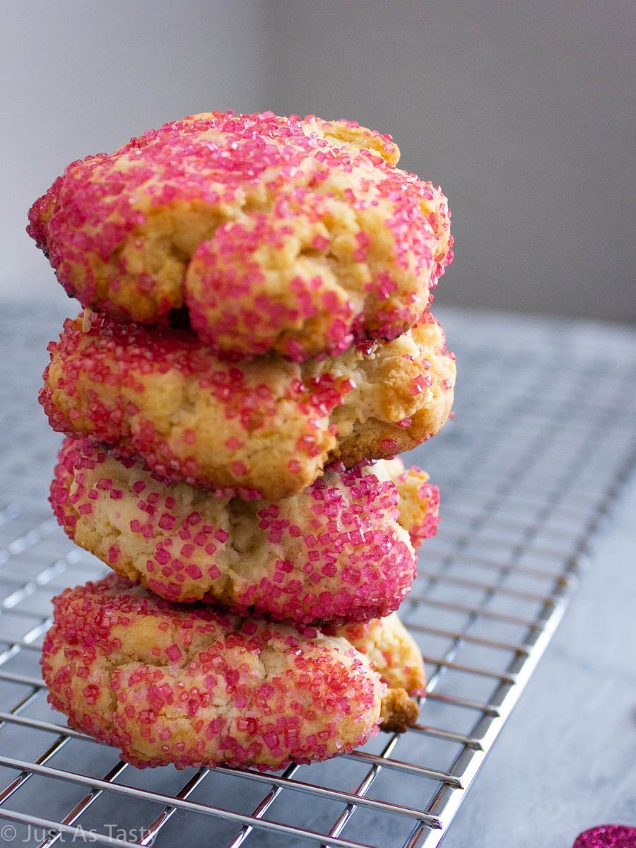 Stack of cream cheese sugar cookies coated in pink sanding sugar.
