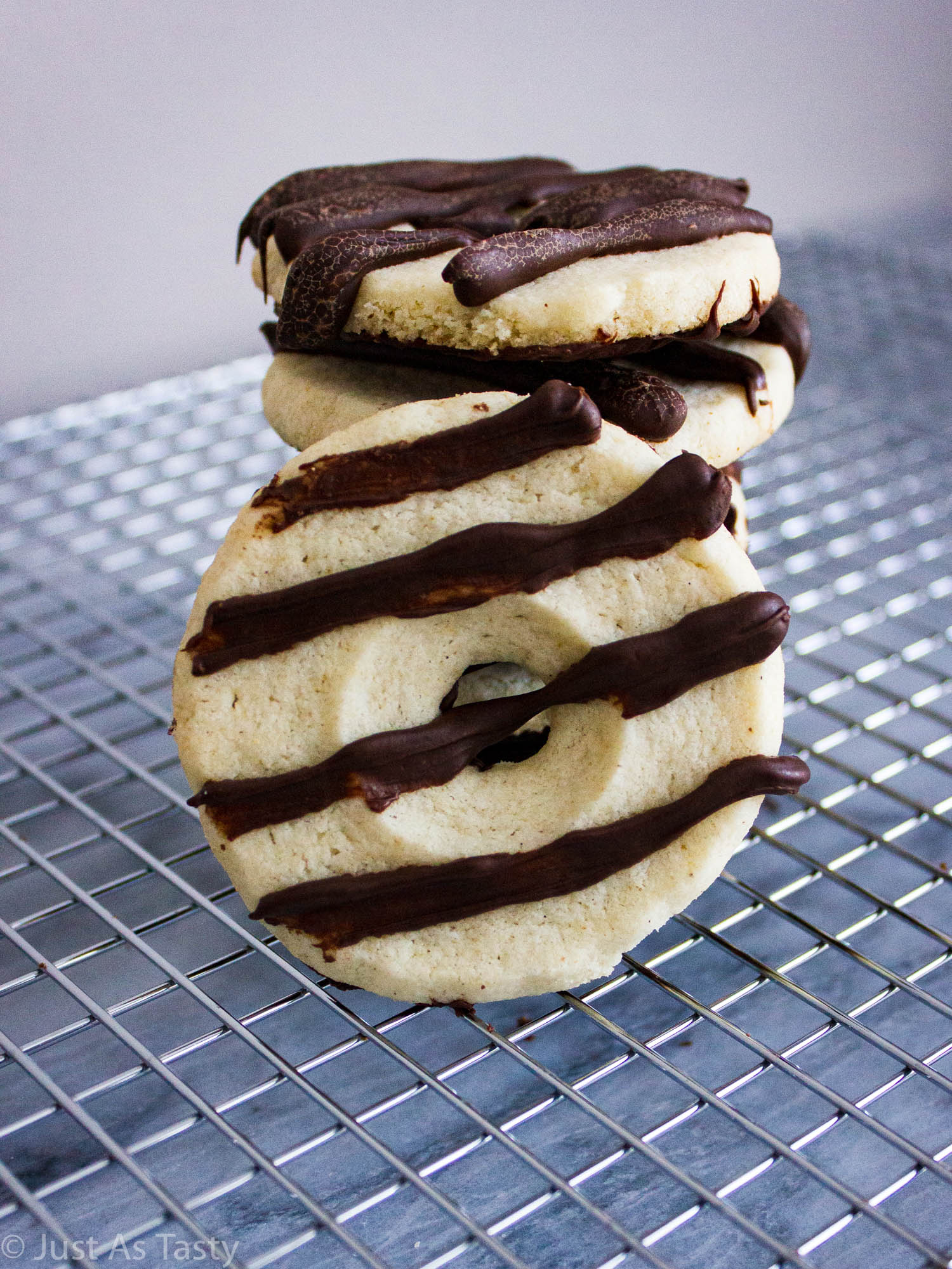 Round fudge stripe cookies on a wire cooling rack.