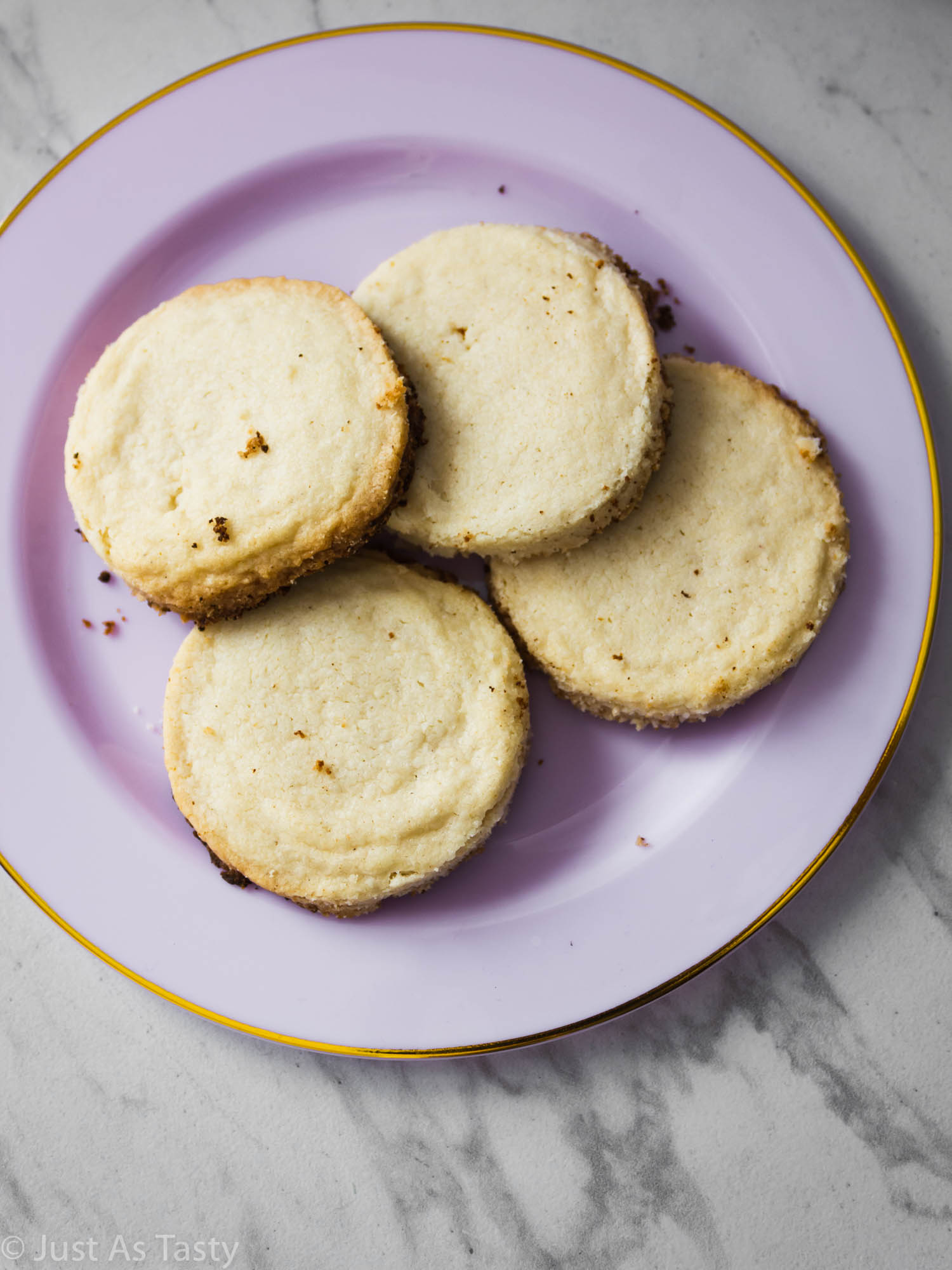 Lavender shortbread cookies on a light purple plate.