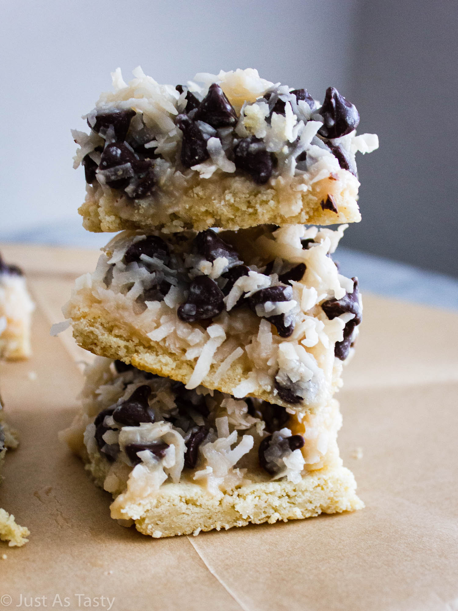 Stack of samoa cookie bars on parchment paper.