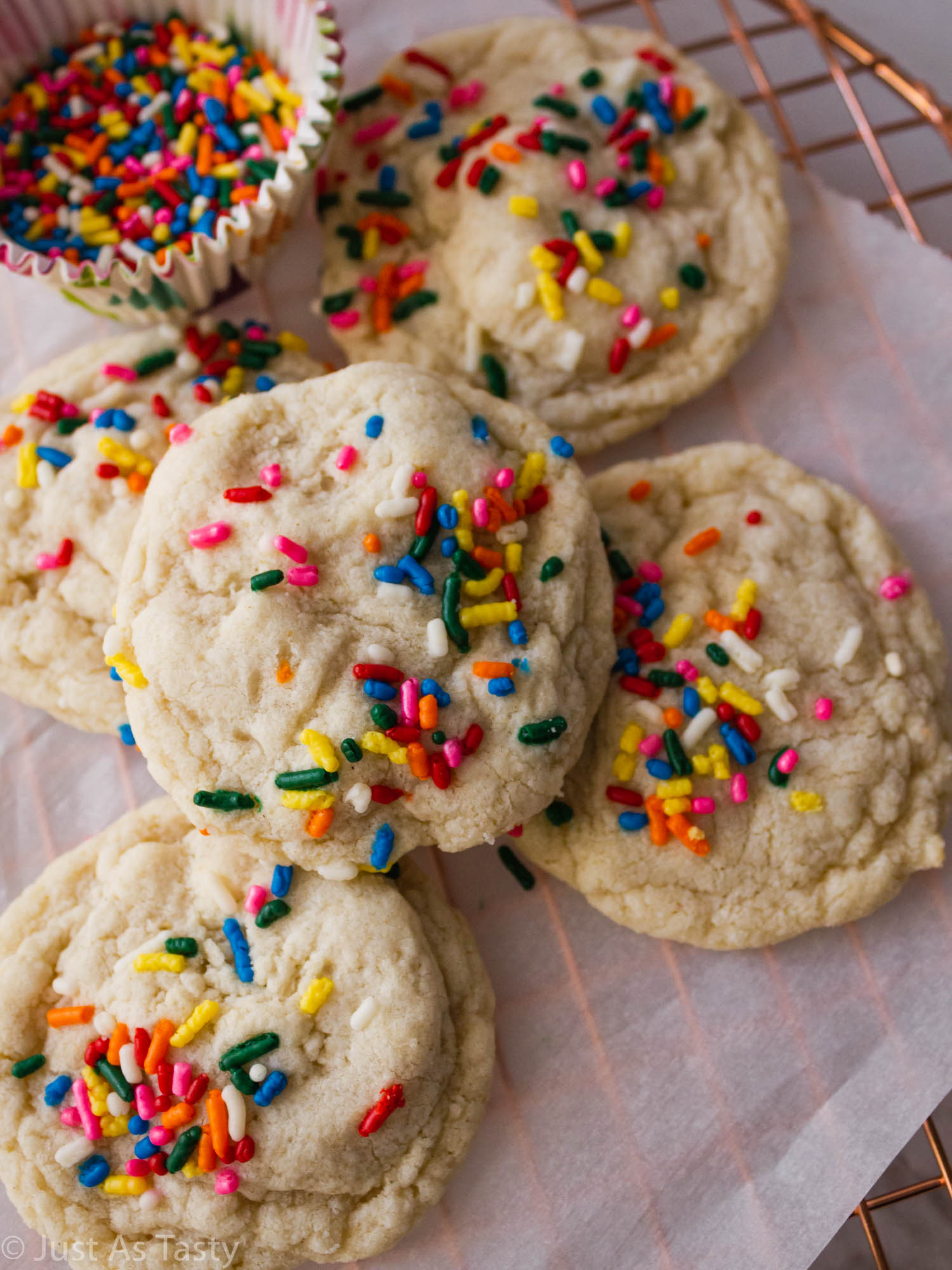 Birthday cake cookies on parchment paper.