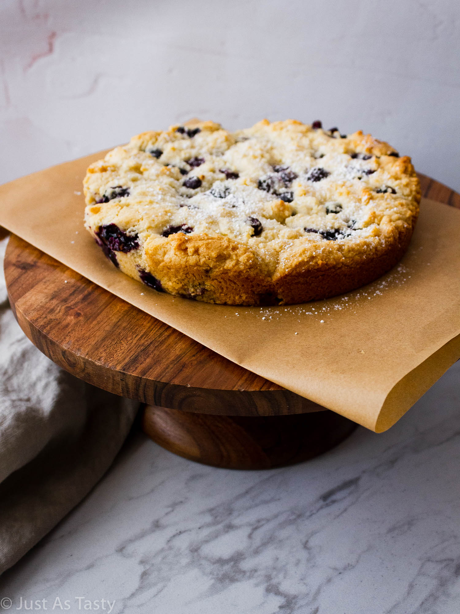 Gluten free blueberry cake on a cake stand. 