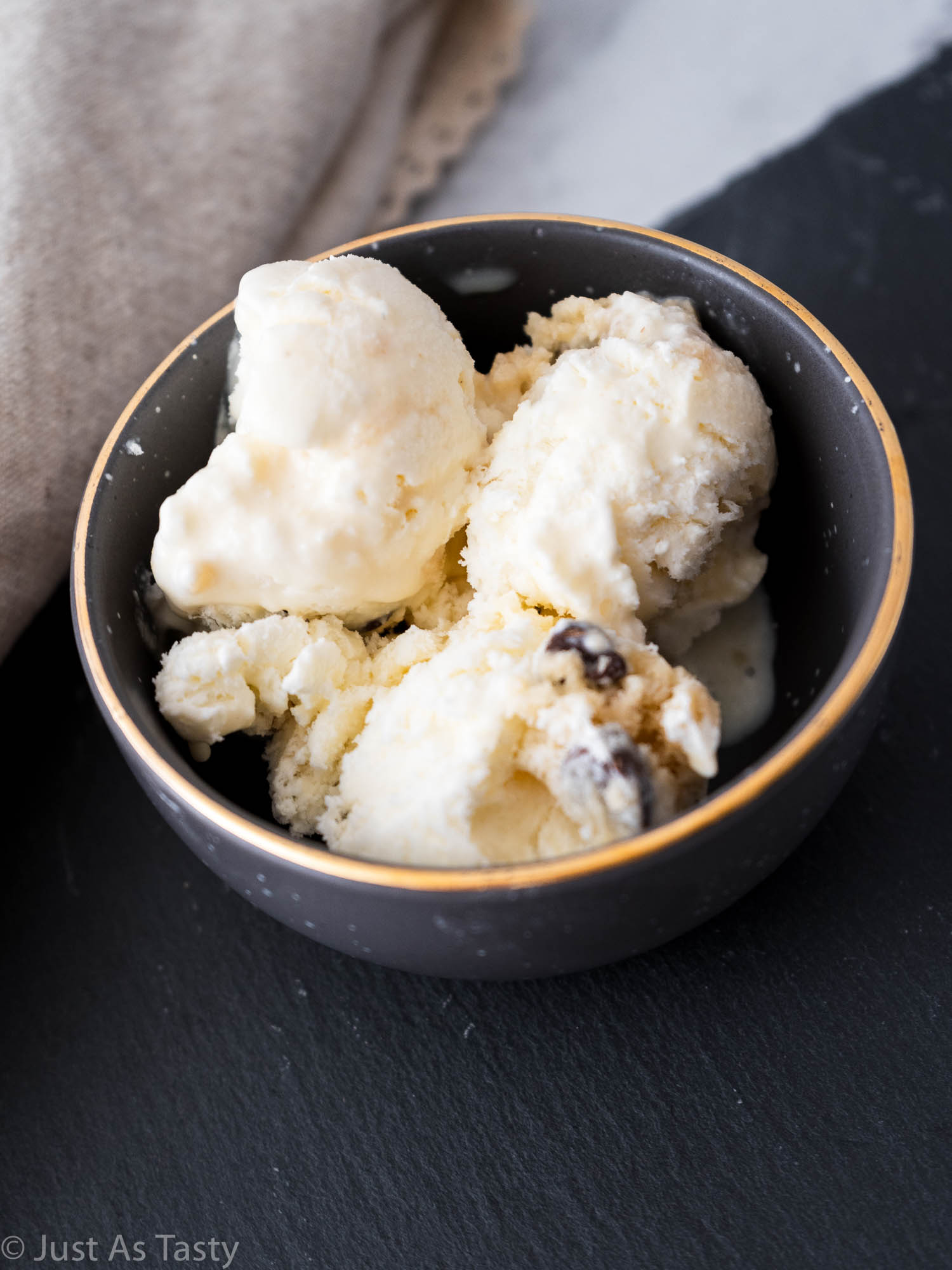 Close-up of cookie dough ice cream in a grey bowl. 