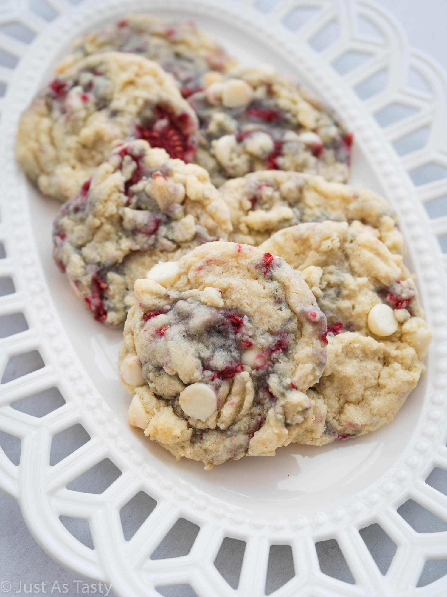 White chocolate raspberry cookies on a white plate.