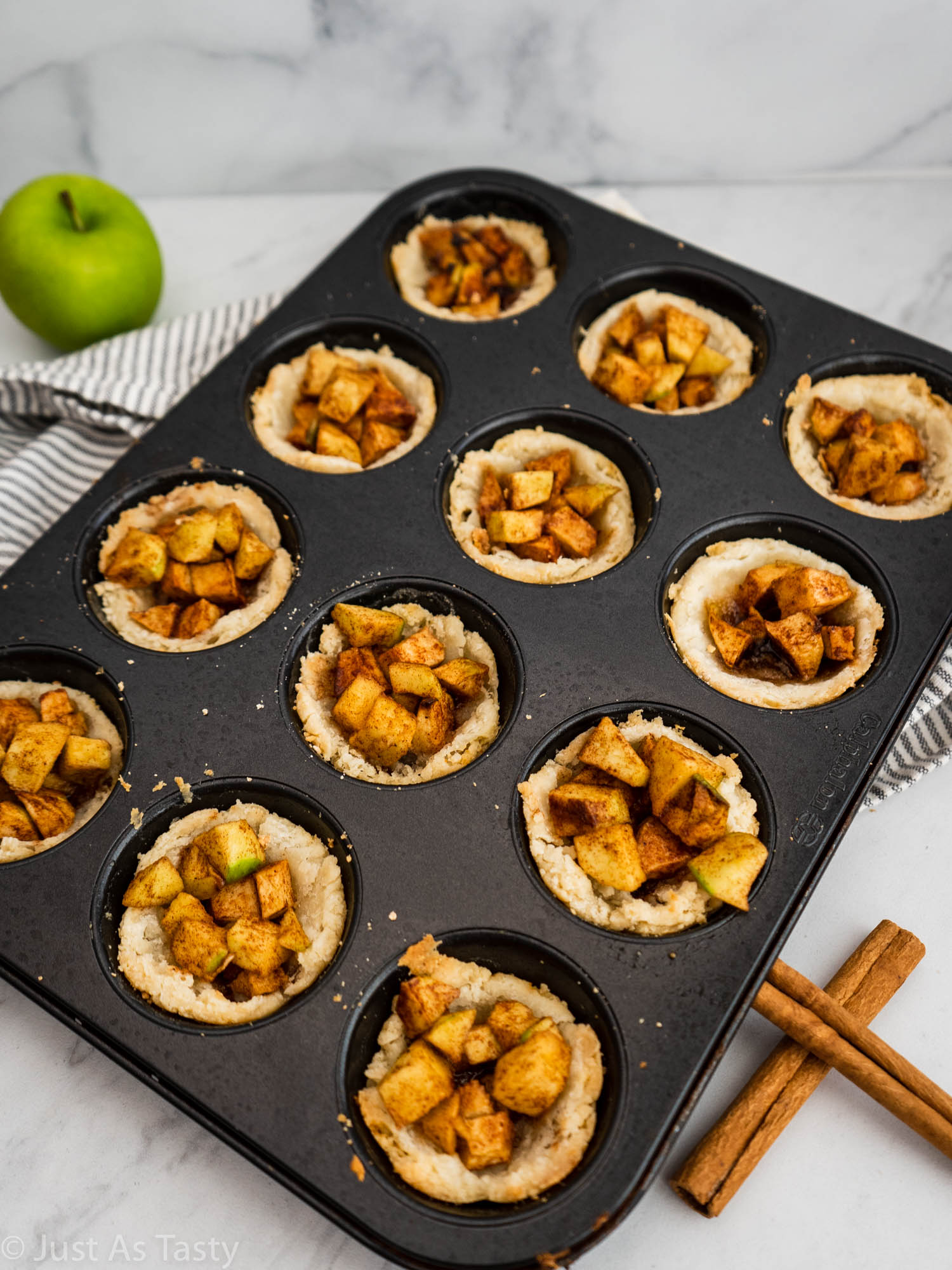 Mini apple pies in a muffin tin. 